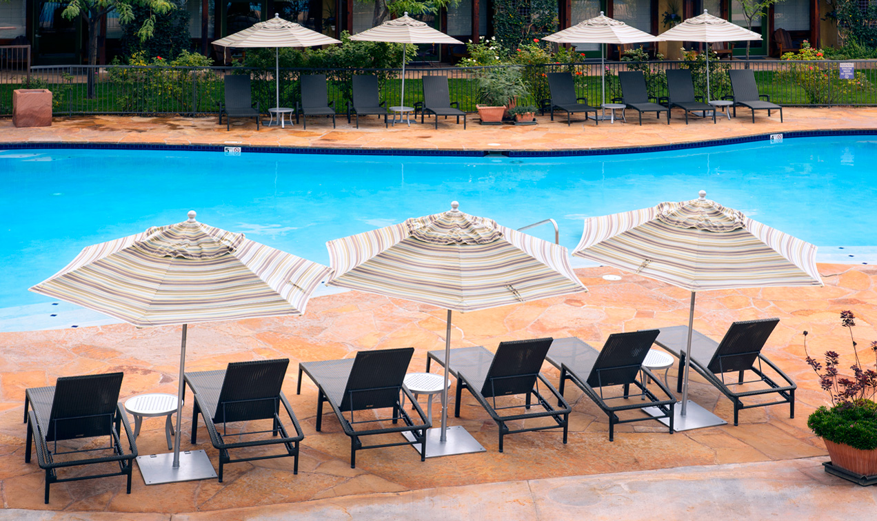 Poolside chairs next to large saline pool at Southern Utah popular family hotel